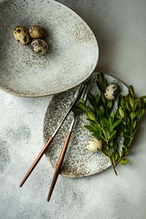 Easter card concept with elegant grey ceramic plates and speckled eggs