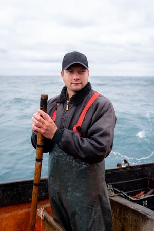 Portrait of a young fisherman on a boat