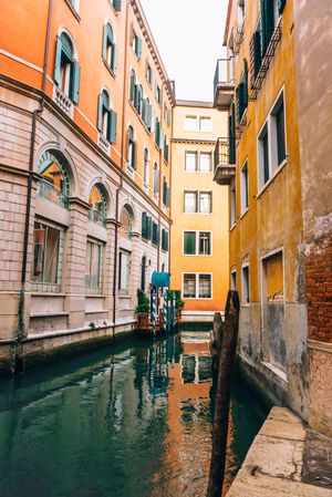 water canal between brown concrete building  in Venice, Italy 