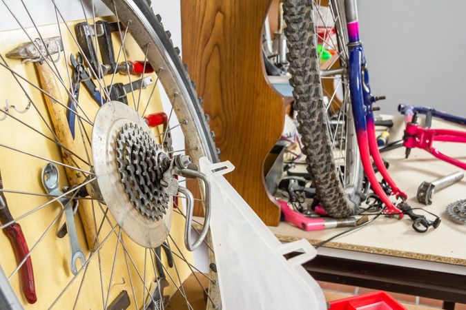 Wheels and bicycle parts over workshop table