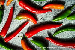 Spicy peppers scattered on grey kitchen counter 4d81ZD