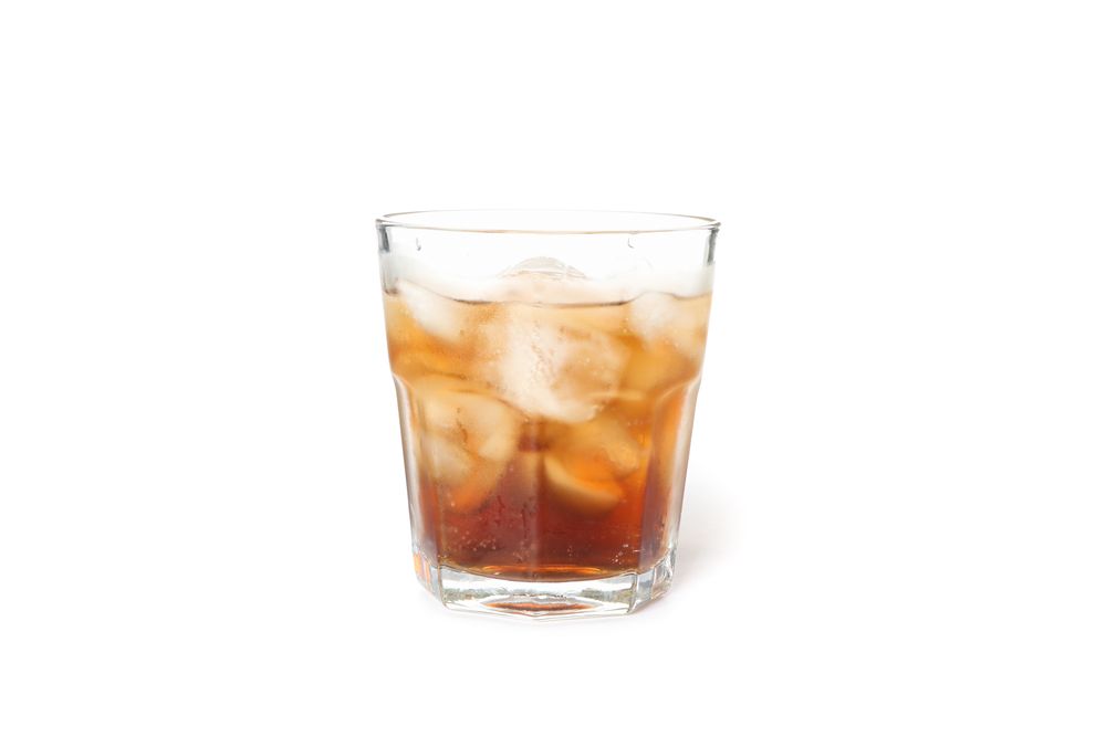 Glass of cold cola isolated on blank background