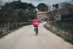 Female riding bicycle without hands