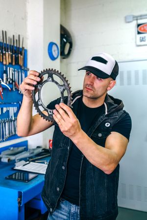 Mechanic reviewing motorcycle sprocket