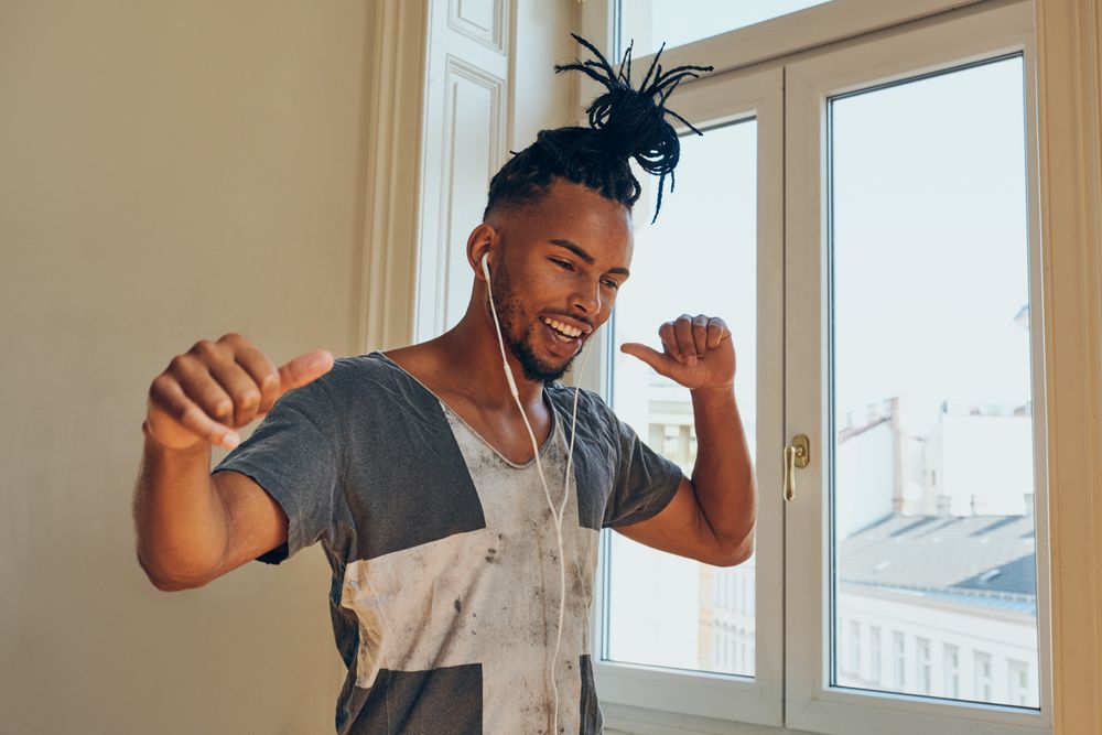 Cheerful Black male listening to music