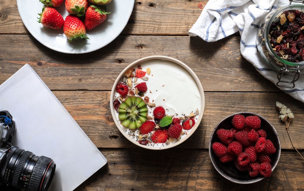 Creamy dessert with ripe strawberry and raspberry with kiwi