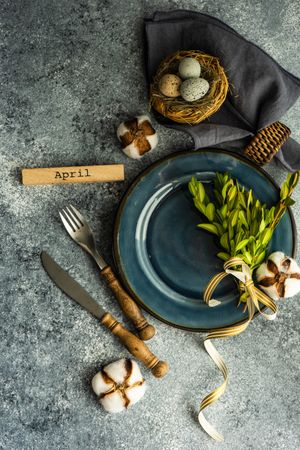 Table setting with branch and delicate nest on grey counter