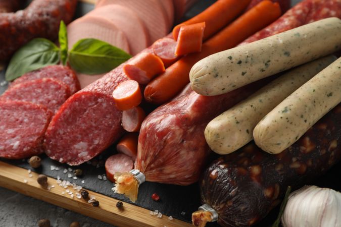 Close up of cured meats on kitchen board