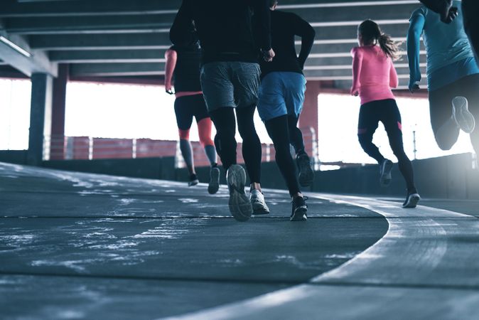 Back shot of legs of runners going around a curve