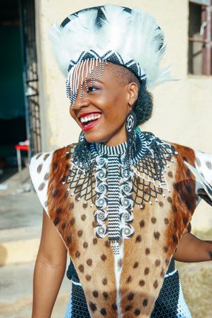 Candid photo of a Zulu bride smiling and looking away