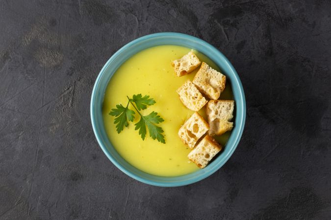 Bowl with onion soup and croutons on the table.