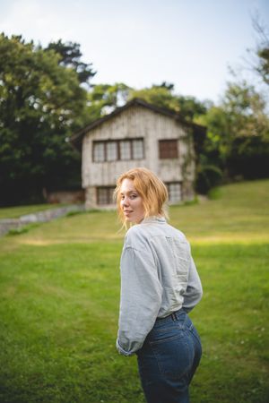 Content female walking on grass in countryside