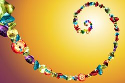Spiral of jewels on yellow background