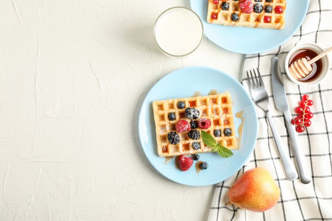 Composition of breakfast with belgian waffles, space for text