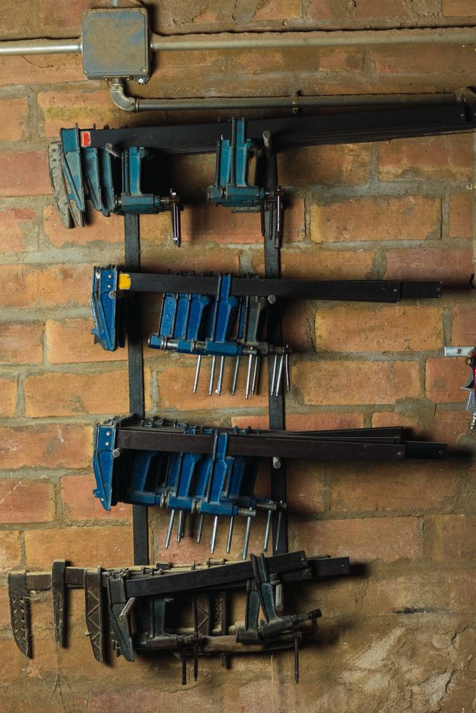 Set of carpentry clamps on metal shelves