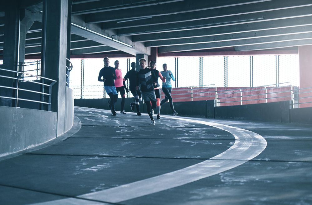 People sprinting down a concrete track