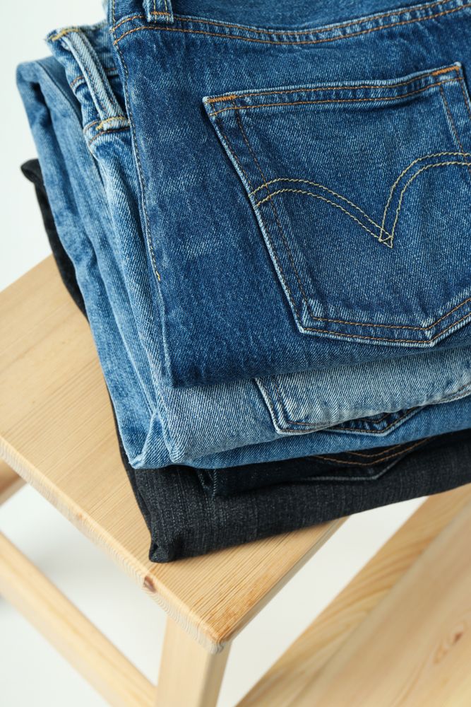 Folded jeans on a wooden chair
