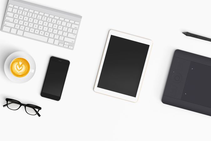 Modern workspace with coffee cup, smartphone, paper, tablet and notebook copy space