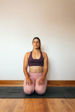 Woman in sportswear doing yoga at home