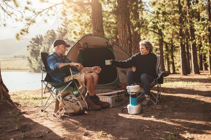 Portrait of couple camping by a lake