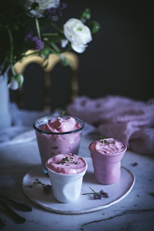 tasty glasses of strawberry mousse on a table with flowers