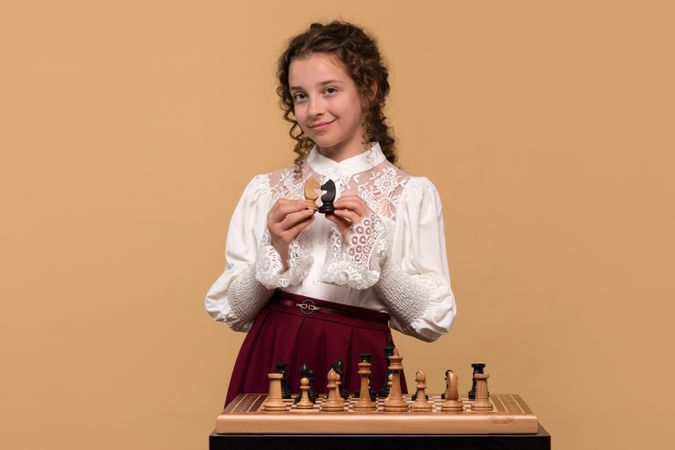 Young girl displaying  chess knights