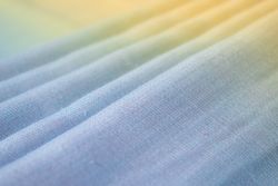 Gradient colorful folded fabric background texture. blue yellow and green.