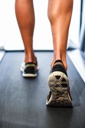 Legs of male on running machine