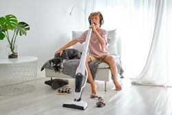 Boy singing into vacuum cleaner