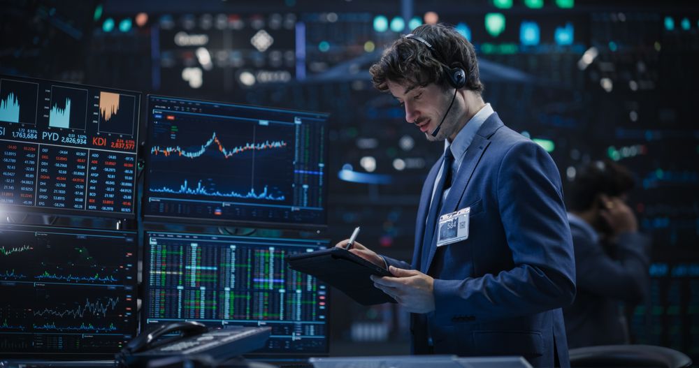 Professional Using a Tablet Computer, Monitoring Financial Markets, Communicating with Corporate Business Partners