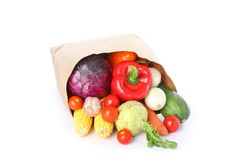 Paper bag with different vegetables isolated on plain background