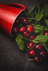 Cherry with branches in cup on table