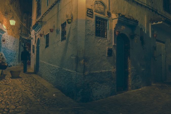 Corner of old building on street of town at night