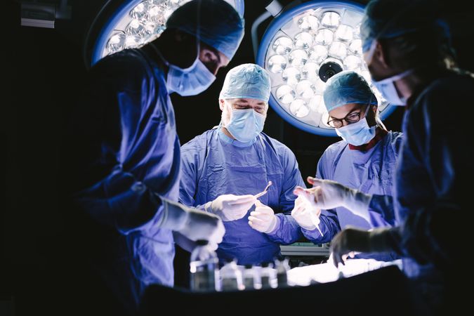 Group of medical professional performing surgery in operation theater