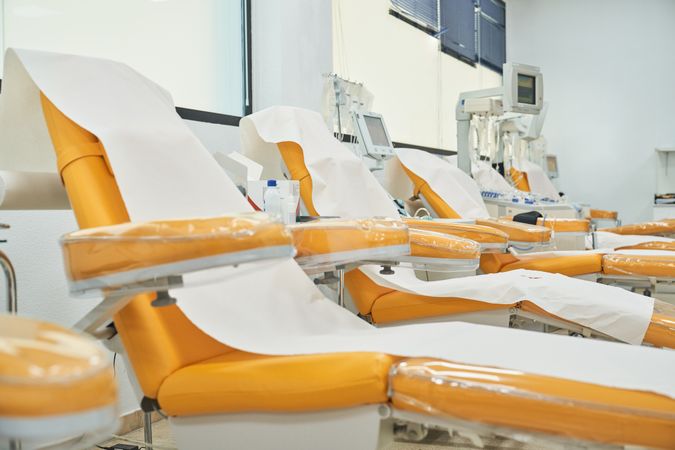 Orange armchairs for sitting in donation center