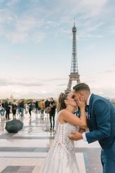 Happy newlyweds in wedding clothing kissing
