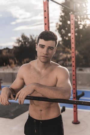 Shirtless man on sports ground