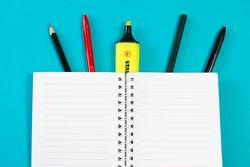 Open notebook with writing tools or school equipment
