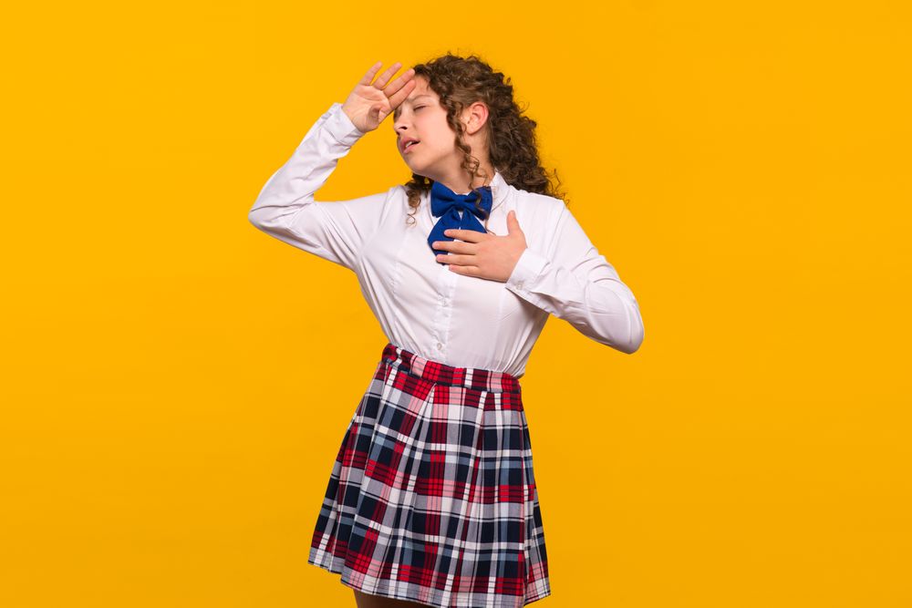 Girl in school uniform posing dramatically