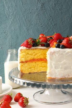 Composition with delicious berry cream cake on wooden table. Tasty dessert
