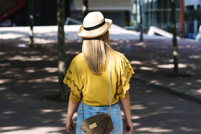 Young blonde woman walking on street