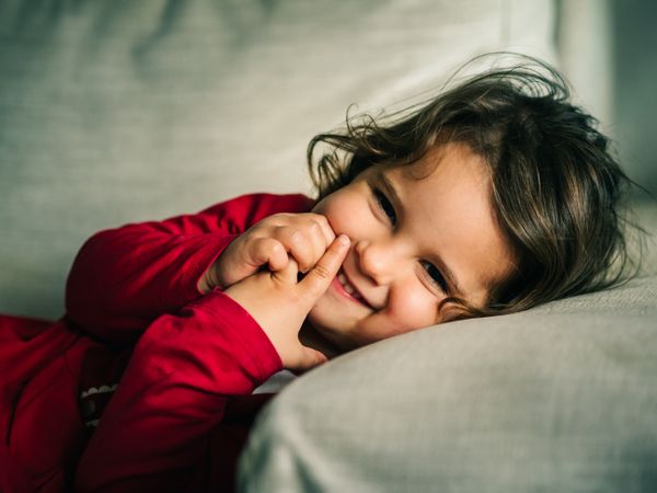 Cute dreamy girl lying down on pillow
