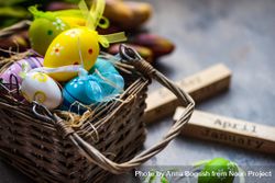 Decorative Easter eggs in basket on table 5qkPQa