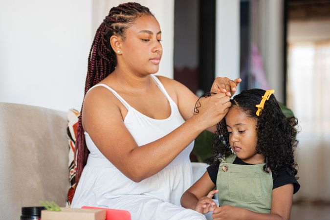 Home Harmony, Mom combs her daughter's hair.