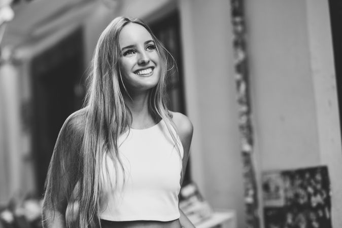 Portrait of smiling woman in vest in b&w