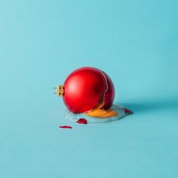 Broken Christmas bauble decoration cracked like a egg with yoke