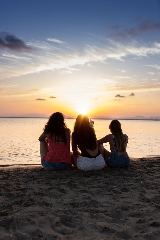 Peaceful fellows embracing on seashore