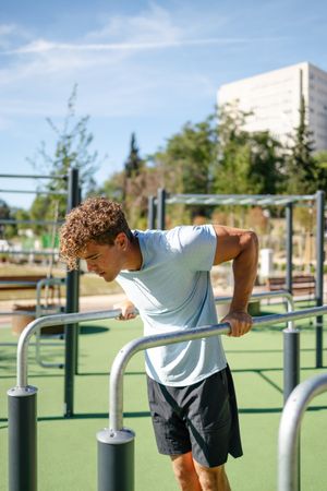 Strong young sportsman doing calisthenics