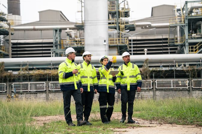 Group of engineer workers checking project at refinery oil factory