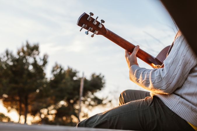Man playing the guitar on the outside